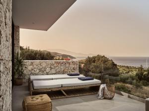 a bedroom with a bed and a view of the ocean at The Sall Suites - Complex B in Agios Nikolaos