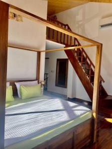 a bedroom with a bunk bed with a staircase at Leeladhar TranquilIty, Luxury Stone Villa in Theog
