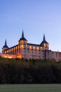 a large building on top of a hill at night at Parador de Lerma in Lerma