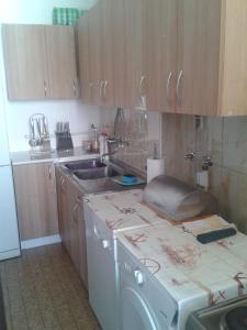 a kitchen with a sink and a counter top at Dena apartman Tivat in Tivat