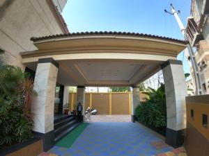 a building with an archway in a courtyard at The Sky Imperial Hotel The Maison in Anand