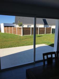 a view of a yard from a window with a chair at Maison située entre plage la mine d'or et bourg in Pénestin