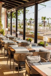 a row of tables and chairs in a restaurant at Hotel Hawaii in Mamaia