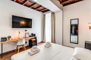 a bedroom with a king sized bed and a desk at Effe Luxury Palace in Rome