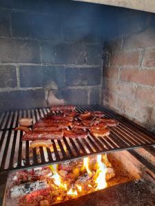- un grill avec de la viande et d'autres aliments dans l'établissement Cabana Trei Brazi Colibita, à Colibiţa