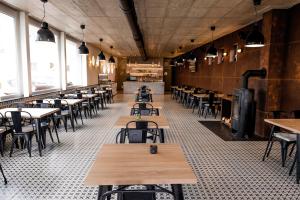 a dining room with tables and chairs and windows at City Hotel B&B in Banská Bystrica