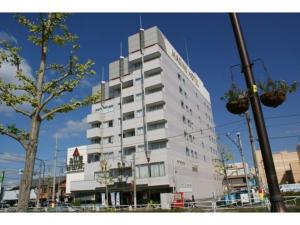 a tall white building on the side of a street at Ichihara Marine Hotel - Vacation STAY 01375v in Ichihara