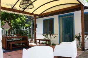 an enclosed patio with two chairs and a table at Blue B&B in Formia