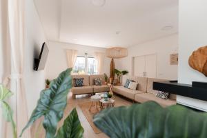 a living room with a couch and a table at Eco Surflodge Azores in Ribeira Grande