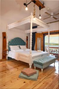 a bedroom with a canopy bed and a wooden floor at Ammou Area in Ammouliani