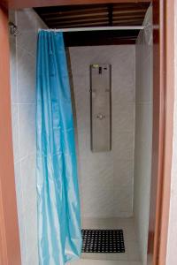 a shower in a bathroom with a blue shower curtain at ASTRA Lančov in Lančov