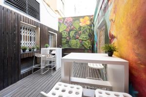 a balcony with a table and chairs and a mural at No Limit Barcelona Central in Barcelona