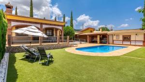 a backyard with a swimming pool and a house at Villa El Lote Salar by Ruralidays in Granada