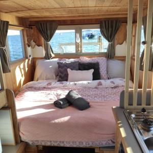 a bed in the middle of a bedroom in at Bateau logement nuit Insolite Astragale in Lège-Cap-Ferret