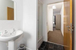 a bathroom with a sink and a walk in shower at Host Liverpool - Spacious Home for Family & Groups in Liverpool