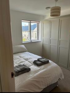 a bedroom with a bed with two towels on it at Sea views in Southwell