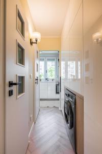 a laundry room with a washer and dryer at Stock Room apartman in Budapest
