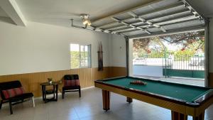 a pool table in a room with a window at Poço by Check-in Portugal in Albufeira