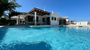 a large swimming pool in front of a house at Poço by Check-in Portugal in Albufeira