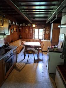 a kitchen with a table in the middle of it at Almzeithütte am Seeberg 