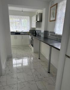 a kitchen with a counter top and a tile floor at PUREWAYS in Southampton