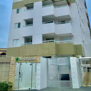 a building with a garage door in front of it at Ap da Tia in Praia Grande