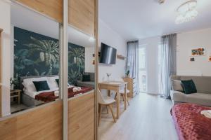 a bedroom with a bed and a desk in a room at Mikro Aparty bezpłatny parking in Wrocław