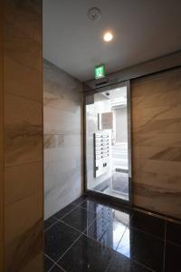 an entrance to a building with a sign on the door at 東駒形302 in Tokyo