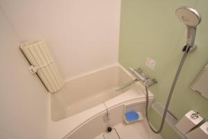 a bathroom with a bath tub with a shower at 東駒形302 in Tokyo