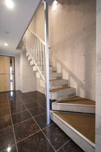 a staircase in a house with a tiled floor at 東駒形302 in Tokyo