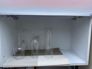 two glass vases sitting inside of a white cabinet at DDUBLE Square in Daegu