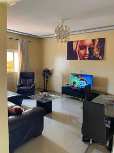a living room with a couch and a table at Your Home III in Yaoundé