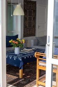 a living room with a table with a vase of flowers on it at Arctic Panorama House in Lødingen