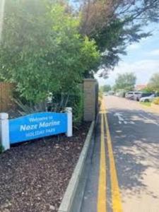 a street with a sign on the side of a road at Julie'scaravan lettings in Kirby Cross