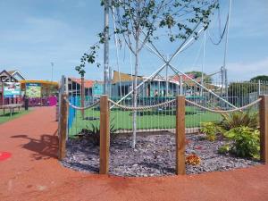 a playground with a rope around a tree at Julie'scaravan lettings in Kirby Cross