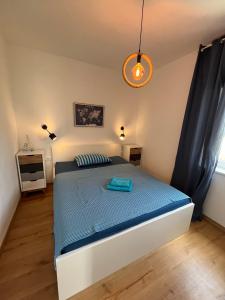 a bedroom with a bed with a blue comforter at Seaview Apartment Villa Sia in Vantačići