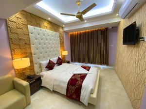 a bedroom with a bed and a ceiling fan at Hotel Valentino in Noākhāli