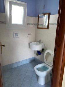 a bathroom with a toilet and a sink at Strati's beach house in Lakkíon