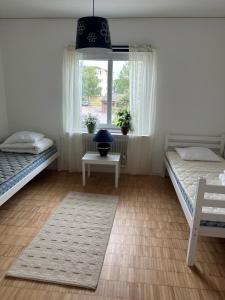 a bedroom with two beds and a window at RFM Tingsryd in Tingsryd