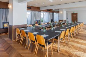 a large conference room with a long table and chairs at magdas HOTEL Vienna City - First Social Business HOTEL in Austria in Vienna