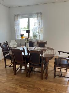 a dining room with a wooden table and chairs at RFM Tingsryd in Tingsryd
