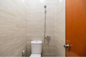 a bathroom with a toilet and a shower at Nyenyak Senayan Benhil in Jakarta