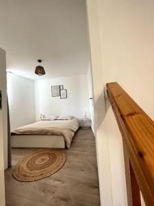 a bedroom with a bed and a wooden floor at Luna - Moon 201 - Romans in Romans-sur-Isère