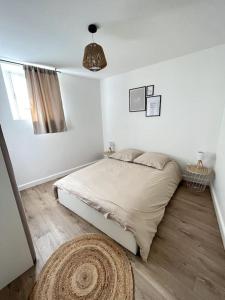 a white bedroom with a bed and a rug at Luna - Moon 201 - Romans in Romans-sur-Isère