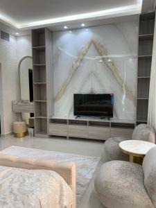 a living room with a large screen with a television at Great Escape for family and friends 4BR Villa with Private Pool and Sea View in Fujairah