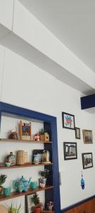 a room with a shelf with plants and pictures at Hôtel de France in Limoges