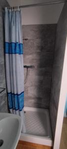 um chuveiro com uma cortina de chuveiro branca e azul em Hôtel de France em Limoges
