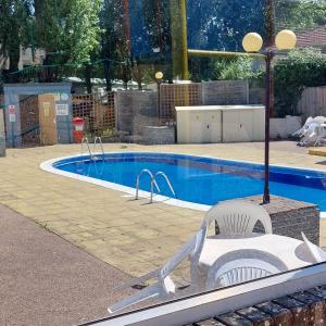 a swimming pool with a white chair and a slide at warden springs caravan park MS16 Thornhill road, Eastchurch,ME124HF in Sheerness