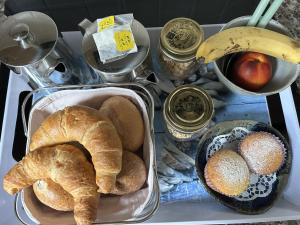 a tray of bread and other foods on a table at B&B Gottardo in Airolo +37 photos