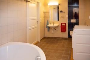 a bathroom with a white toilet and a sink at Arctic Panorama House in Lødingen